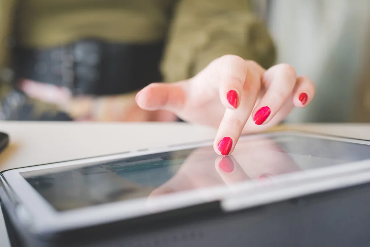 Close Up On The Hand Of A Young Handsome Caucasian Girl Using Te